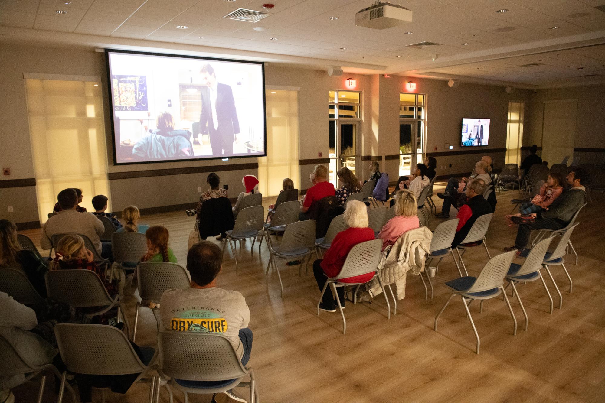 A group of Lewisville residents enjoy a holiday movie night at the Mary Alice Warren Community Center.